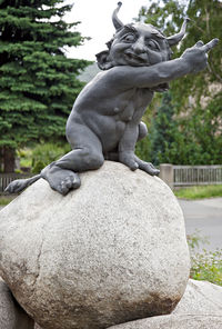 Statue of rock against trees