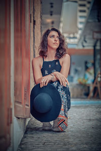 Portrait of young woman sitting outdoors