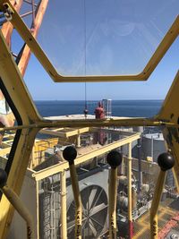 View from inside crane on offshore production platform while dumping oil 