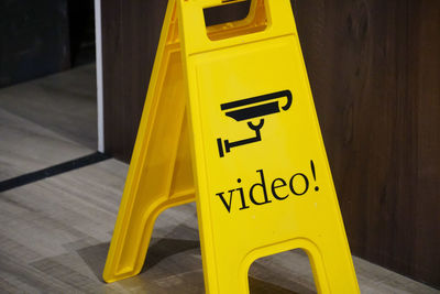 High angle view of yellow sign on table