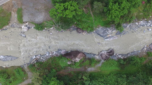 High angle view of water flowing over rocks by sea