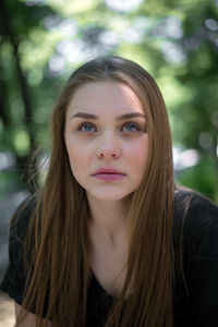 Close-up of beautiful young woman looking away