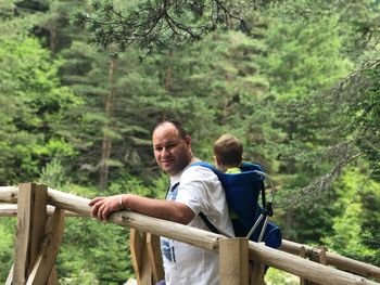 Father with baby boy while hiking in forest