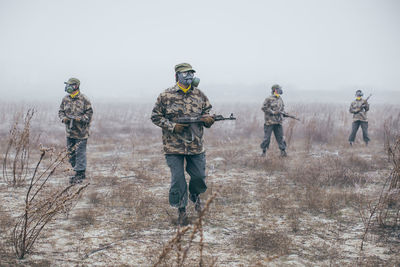 Soldiers walking through field looking for enemy