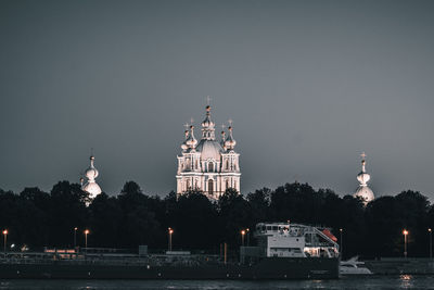 Illuminated building against sky in city