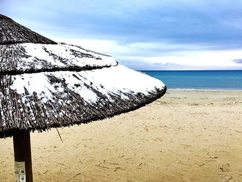 Close-up of beach against sky