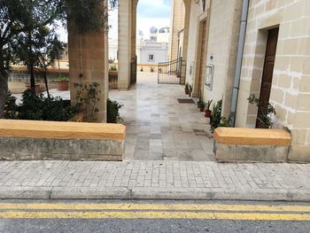 Steps amidst buildings against sky