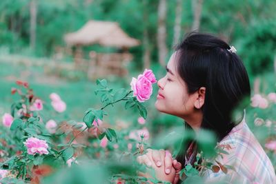 Portrait of woman on pink flowering plants