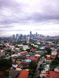 Cityscape against cloudy sky