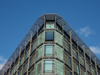 Low angle view of modern building against clear blue sky