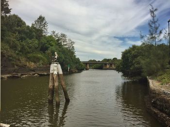 Reflection of man in lake against sky