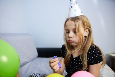 Children have fun playing, blowing up colorful balloons, at a birthday party