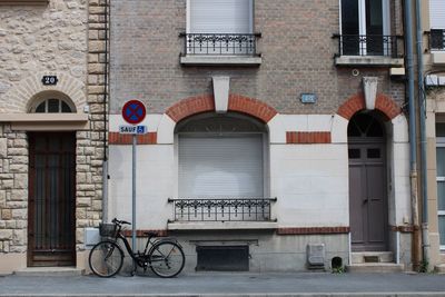 Bicycle on street against building