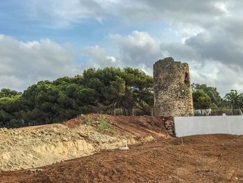 Old ruins by building against sky