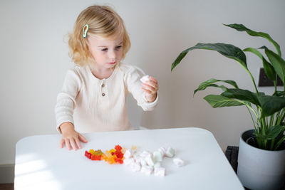 Portrait of cute girl eating food on table