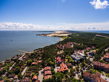 High angle view of townscape and sea against sky