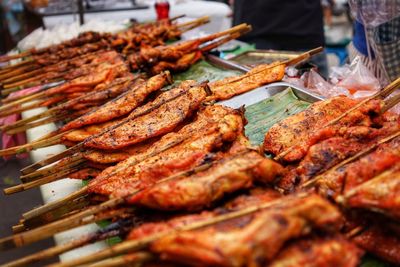 Close-up of grilled meat in skewers at market stall