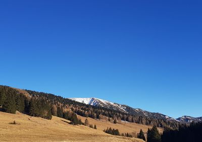 Scenic view of mountains against clear blue sky