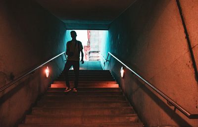 Rear view of people walking on stairs