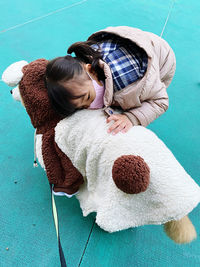 High angle view of girl with dog outdoors