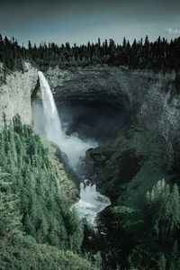 Scenic view of waterfall against sky