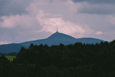 Silhouette of trees against cloudy sky