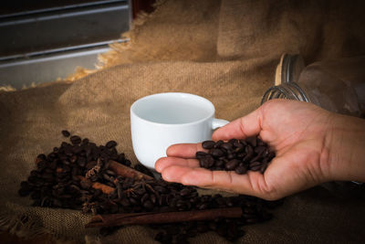 Cropped image of hand holding coffee cup