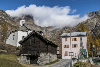 Traditional building by mountains against sky