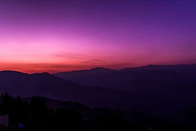 Scenic view of silhouette mountains against sky at sunset