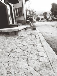 Footpath by street and buildings in city