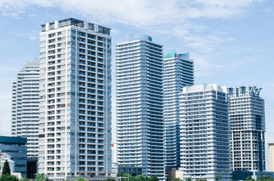 Low angle view of modern buildings in city against sky