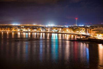 Night view of illuminated coastal town arinaga. gran canaria, spain