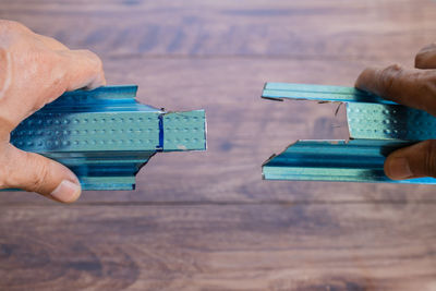 Close-up of hand holding toy blocks on table