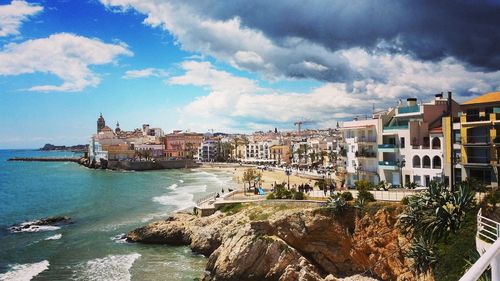 View of buildings by sea against sky