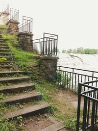 Stairs leading to built structure against clear sky