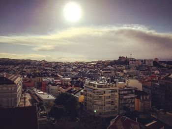 Cityscape against cloudy sky