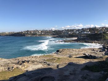 Scenic view of sea and buildings against sky