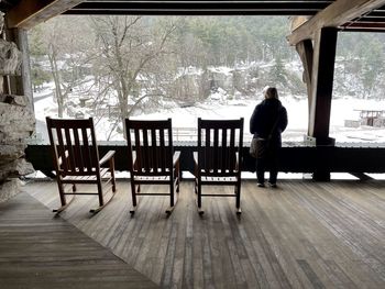 Rear view of woman sitting on table