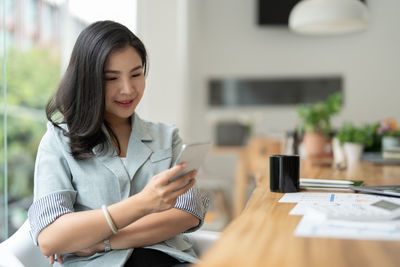 Portrait of young woman using mobile phone