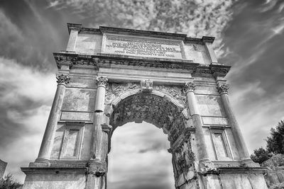 Low angle view of old building against cloudy sky