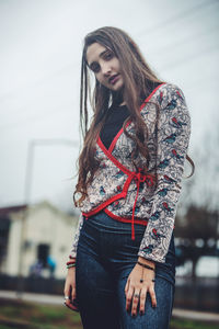 Portrait of a beautiful young woman standing outdoors