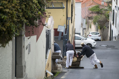 People on street amidst buildings in city