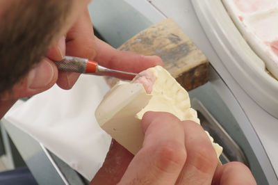 Cropped image of dentist making dentures