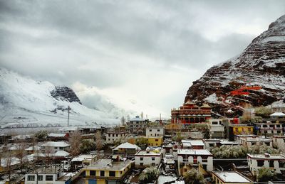 Panoramic view of houses and mountains against sky