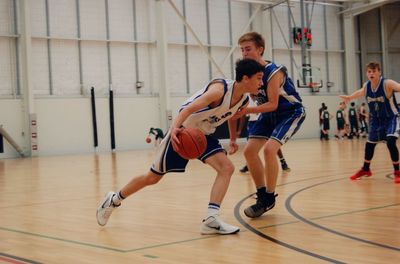 Men playing with basketball hoop