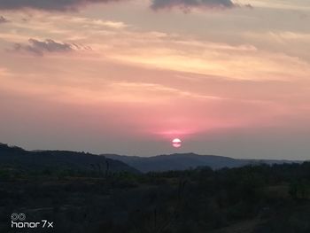 Scenic view of mountains against romantic sky at sunset