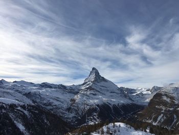 Scenic view of snow covered mountains against sky