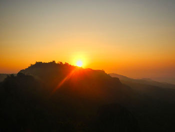 Scenic view of silhouette mountains against sky during sunset