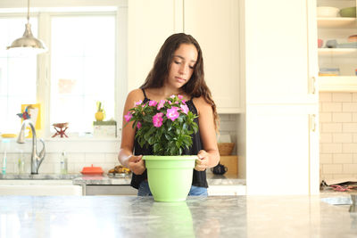 Young woman standing at home