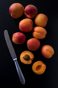 High angle view of fruits on table against black background